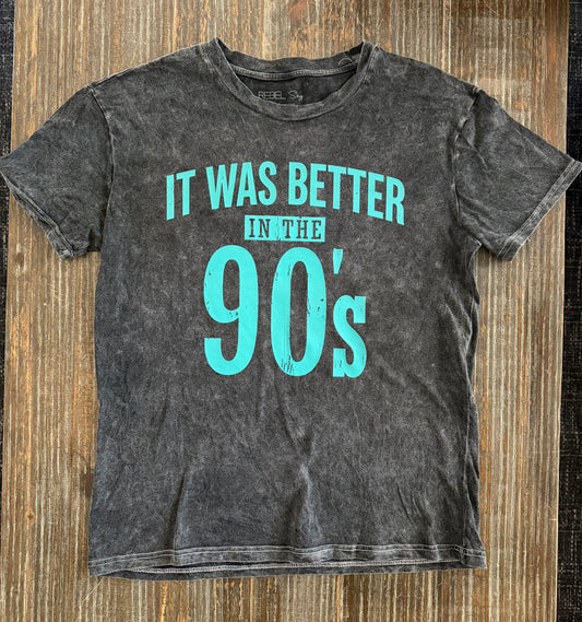 Black vintage-style t-shirt with turquoise 'It Was Better In The 90's' graphic on wooden surface